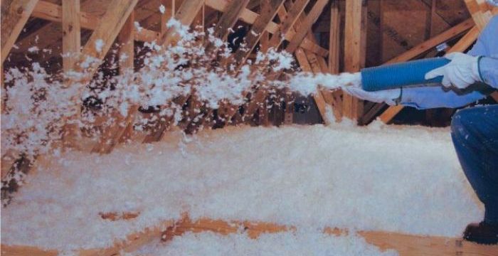 men wearing blue shirt blowing foam to attic for insulation