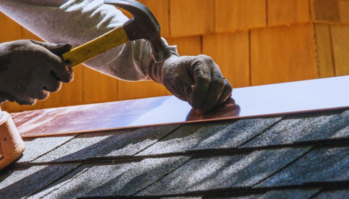 man putting flashing on roof