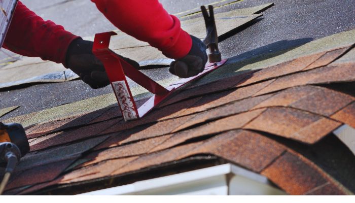 Roof worker maintaining the Roof 