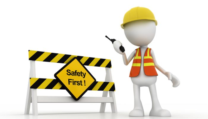 worker with safety first sign
