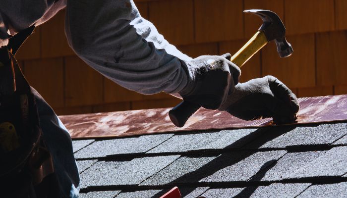 man nailing roof flash 