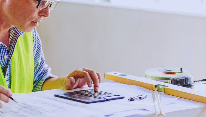 man calculating cost for repair 