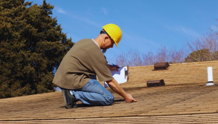 Man on the roof checking the leak