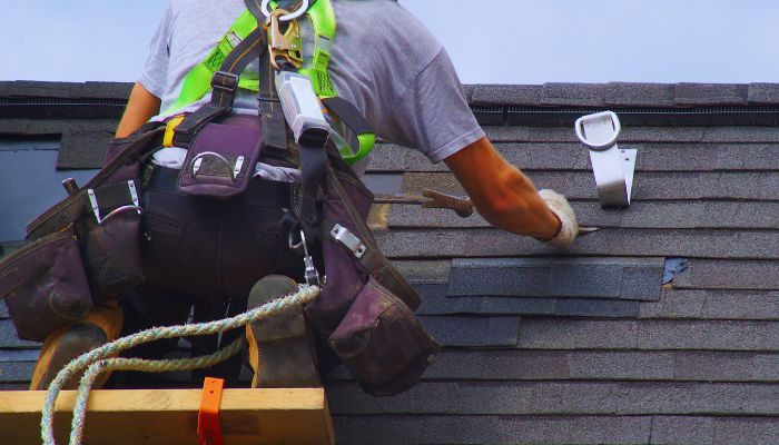 man fixing the leak on roof 